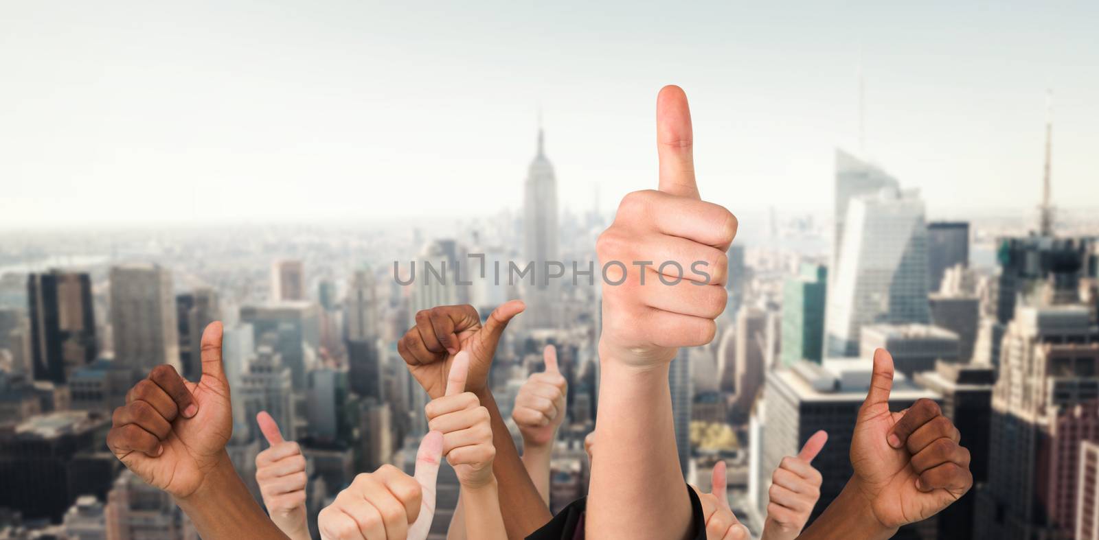 Hands showing thumbs up against new york