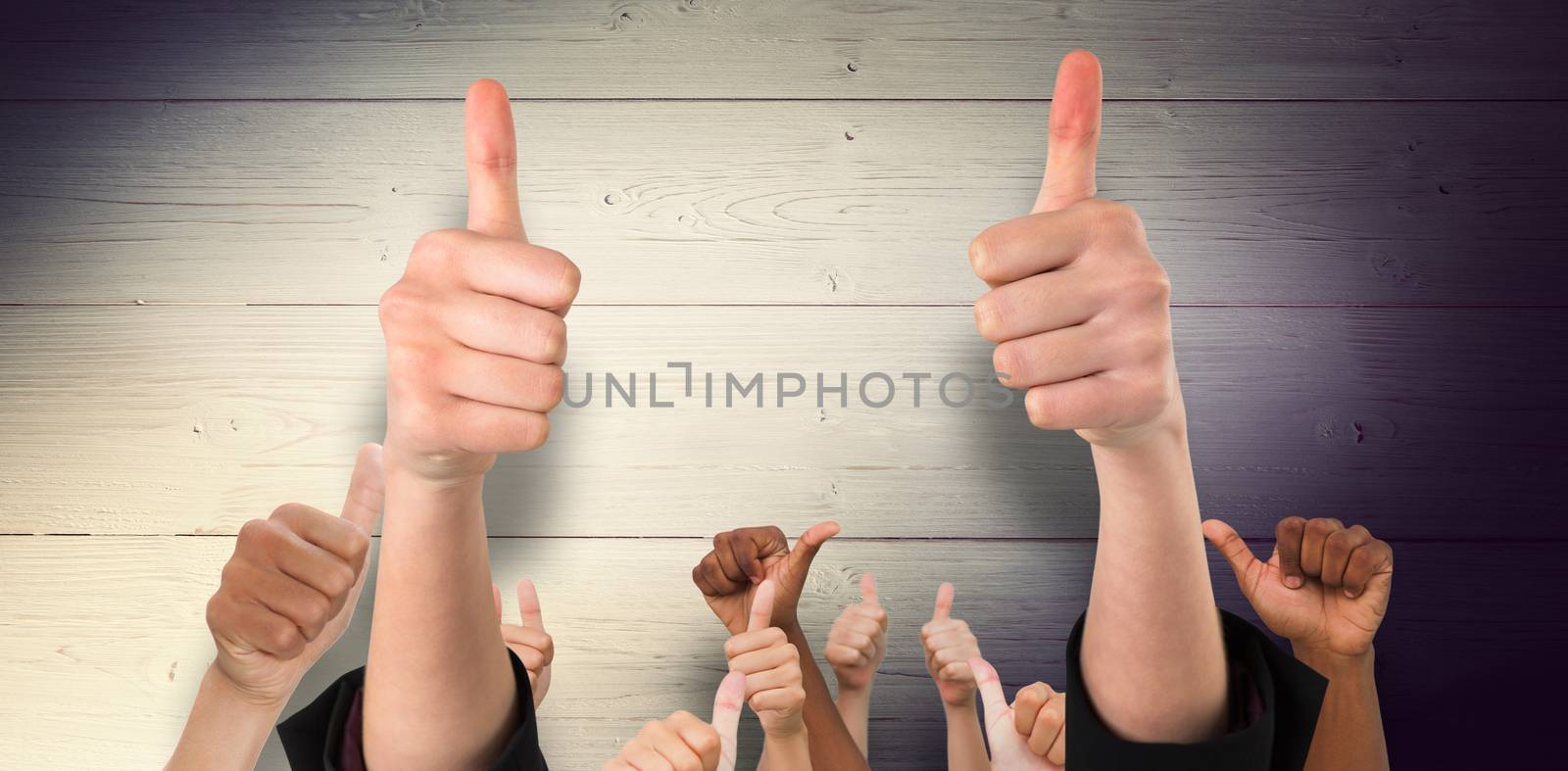 Hands showing thumbs up against shadow on wooden boards