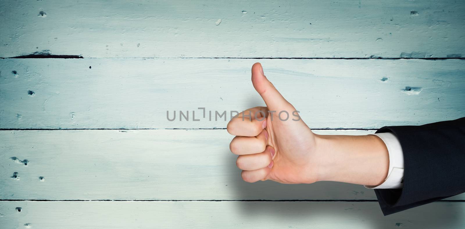 Hand showing thumbs up against painted blue wooden planks