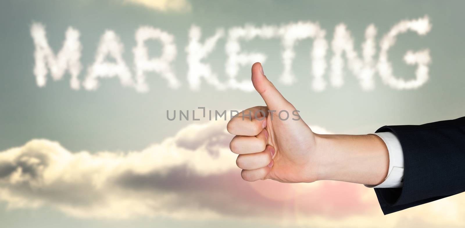 Hand showing thumbs up against clouds spelling out marketing