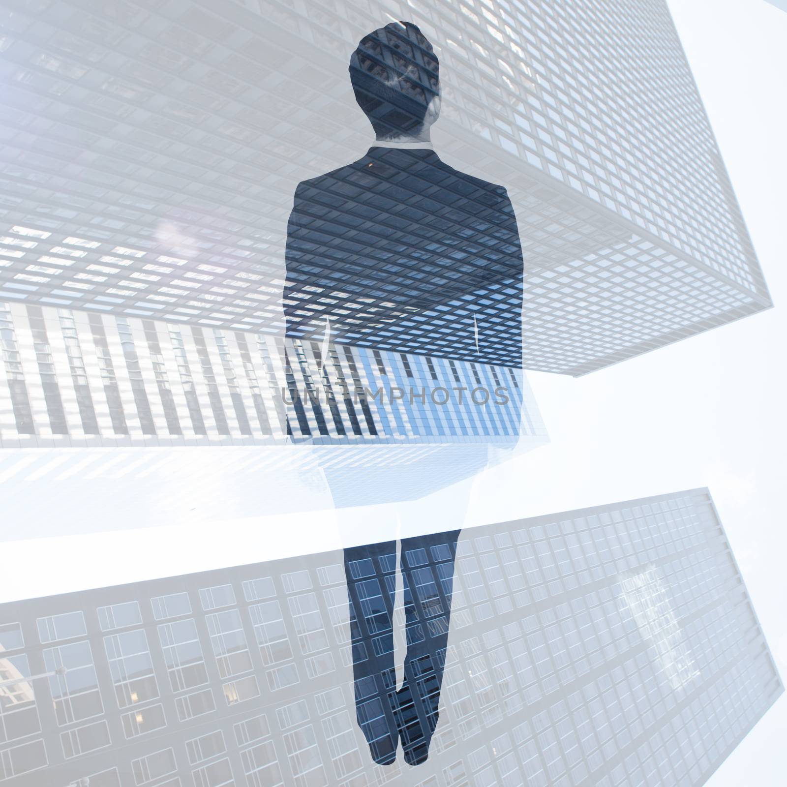 Asian businessman against low angle view of skyscrapers