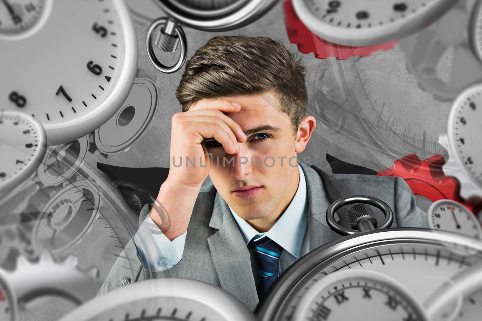 Serious businessman against grey background