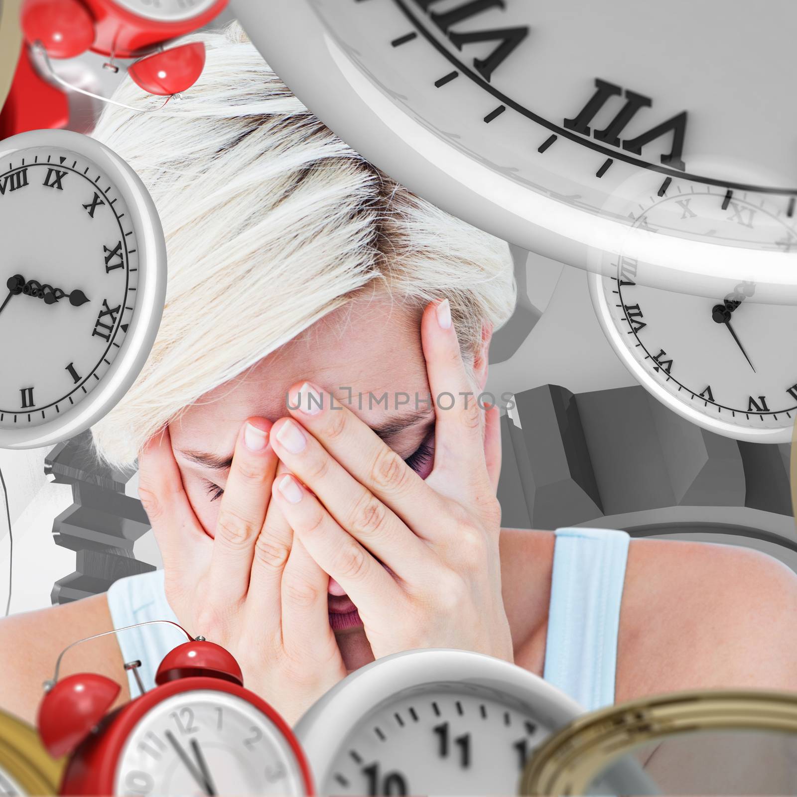 Sad blonde woman crying with head on hands  against grey vignette