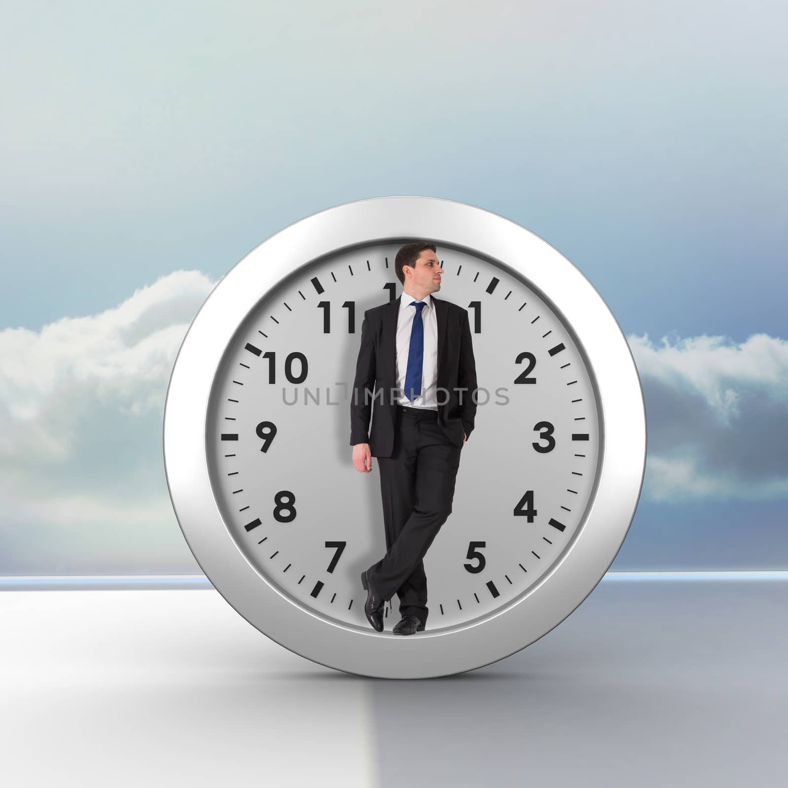 Handsome businessman leaning against clouds in a room
