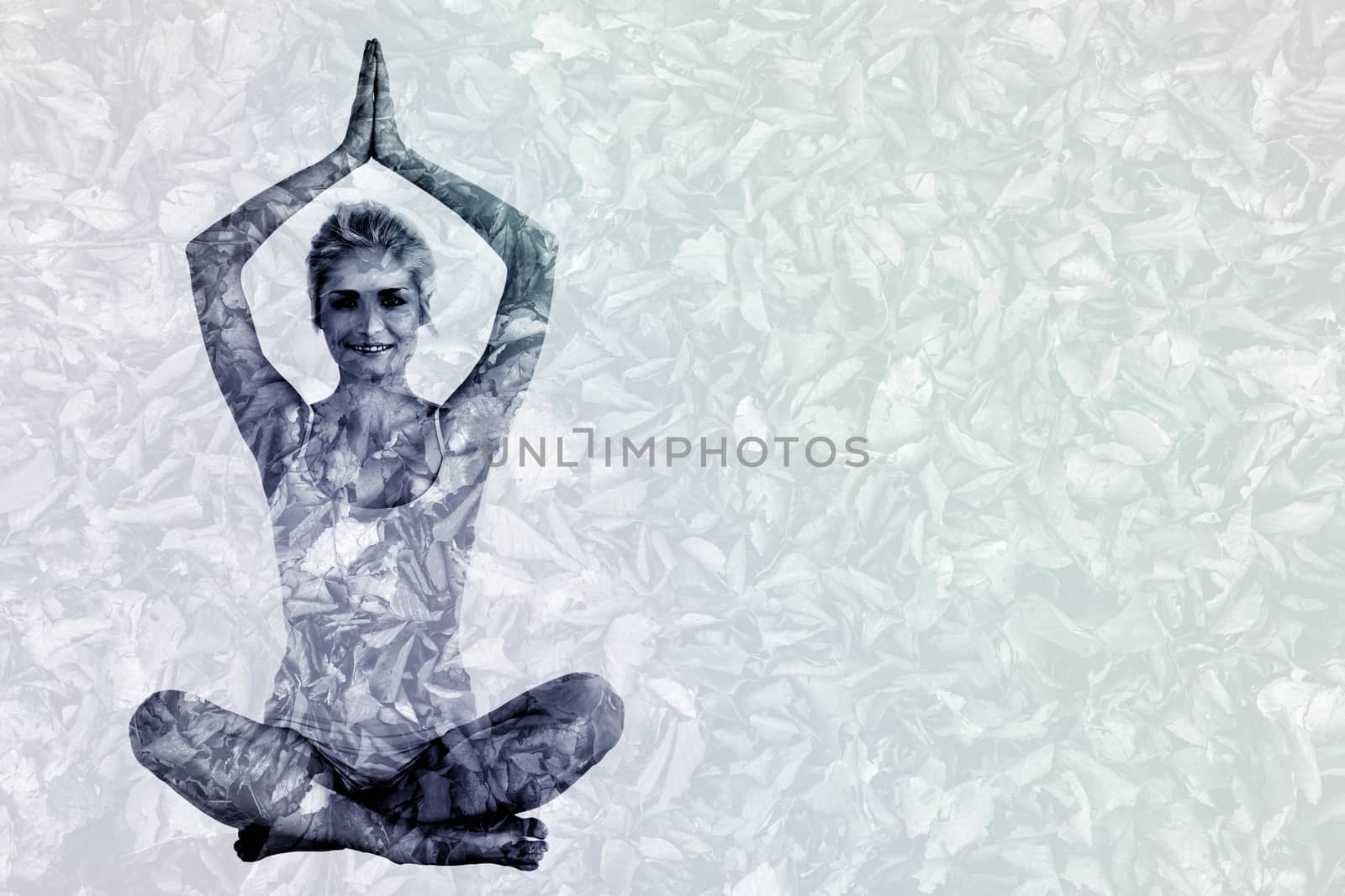 Toned young woman sitting with joined hands over head against detail shot of dry leaves