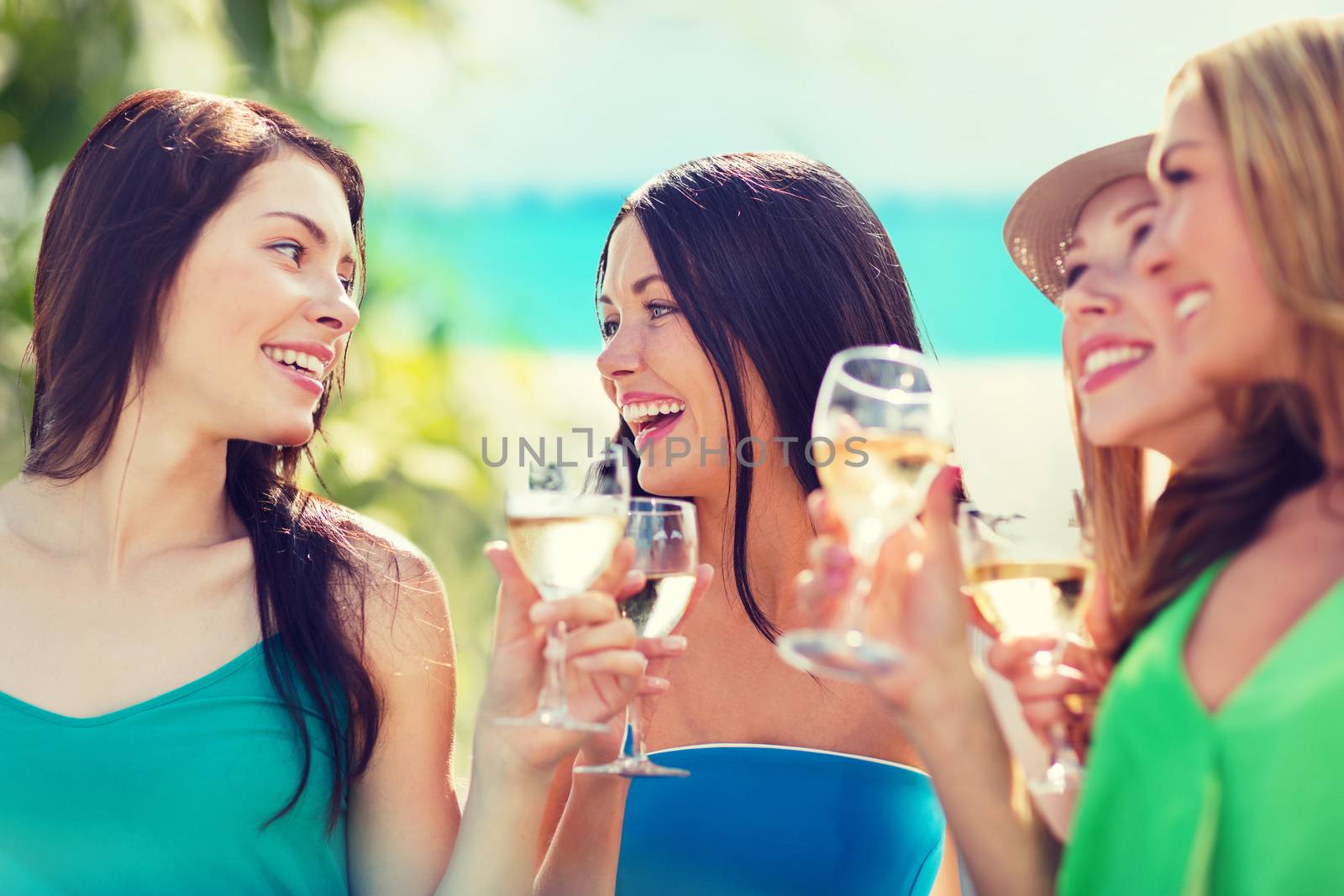 summer holidays, vacation and celebration - girls with champagne glasses