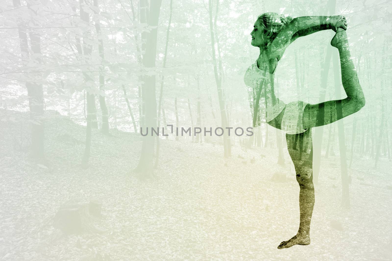 Sporty woman stretching body while balancing on one leg against trees in the autumnal forest