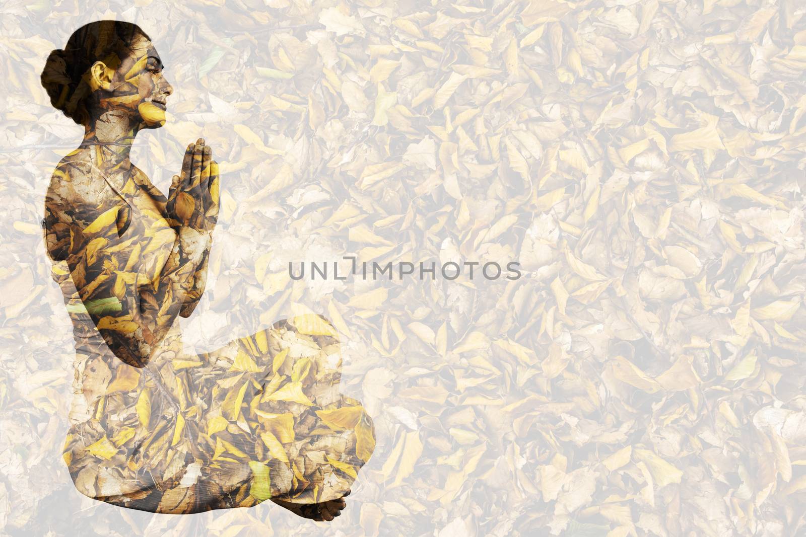 Content brunette in white sitting in lotus pose  against detail shot of dry leaves