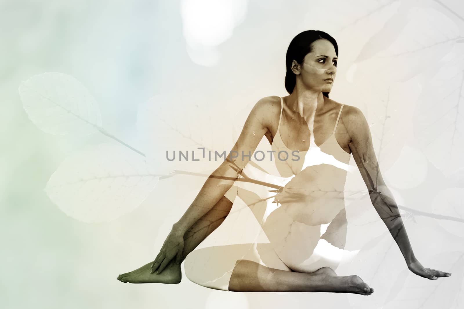 Composite image of fit woman doing the half spinal twist pose in fitness studio by Wavebreakmedia