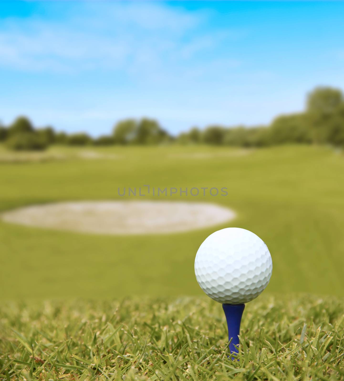 Golf ball on course with beautiful blurry landscape on background