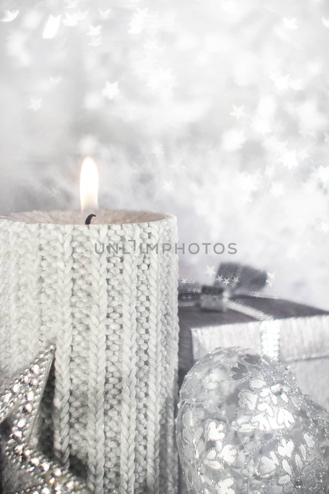 Beautiful shiny silver christmas decor and burning candle