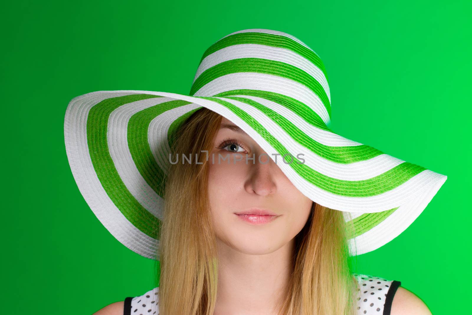 Girl in a green hat in the beach strip. horizontal. Crop