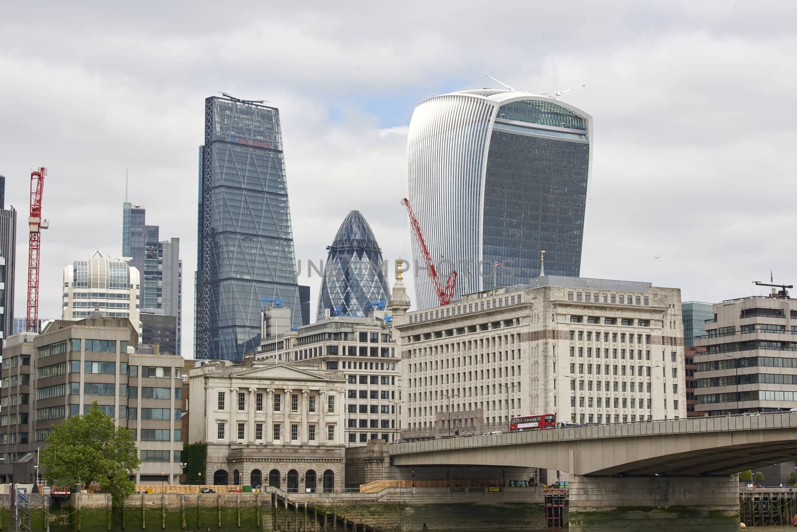LONDON, UK - JUNE 23: The Walkie-Talkie, Cheese Grater, and Gherkin, seen from London Bridge. June 23, 2015 in London.