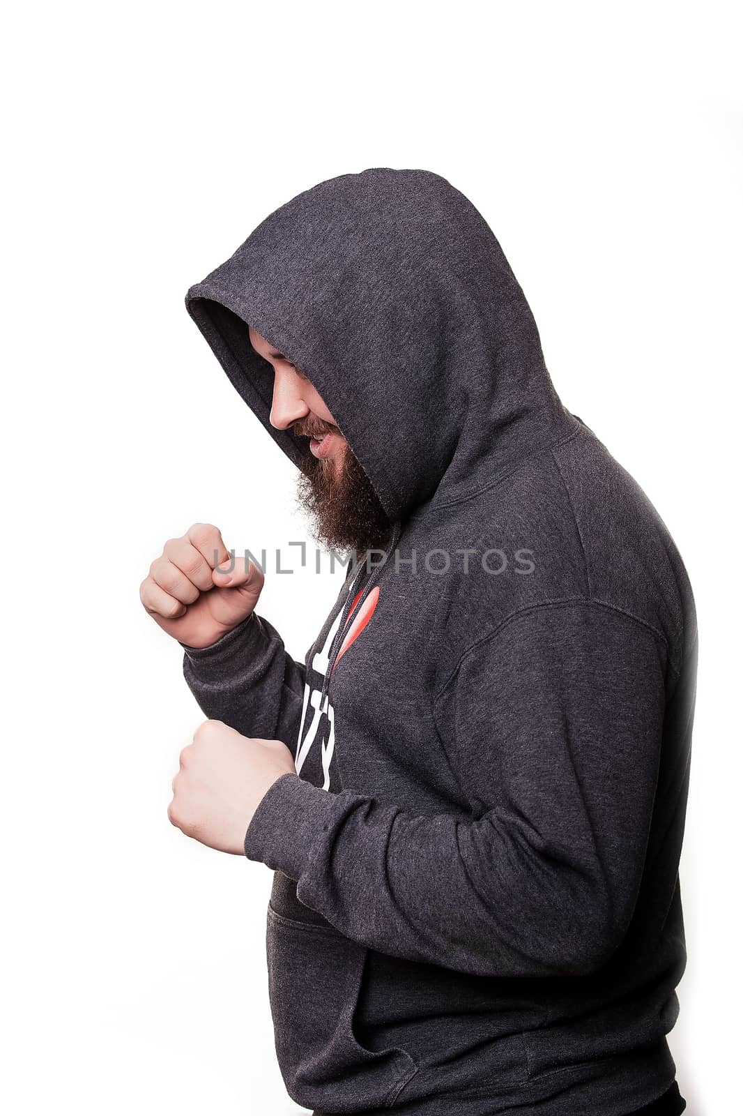 Boxer with a serious face with a beard in the hood in training. Isolated on white background