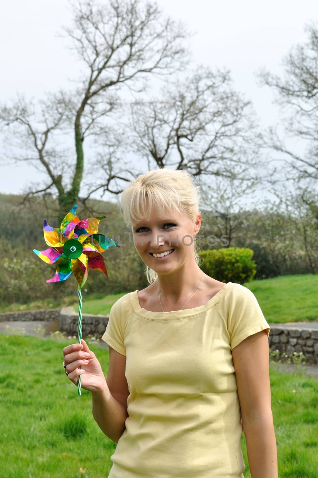 Portrait of blond woman with coloured pinwheel