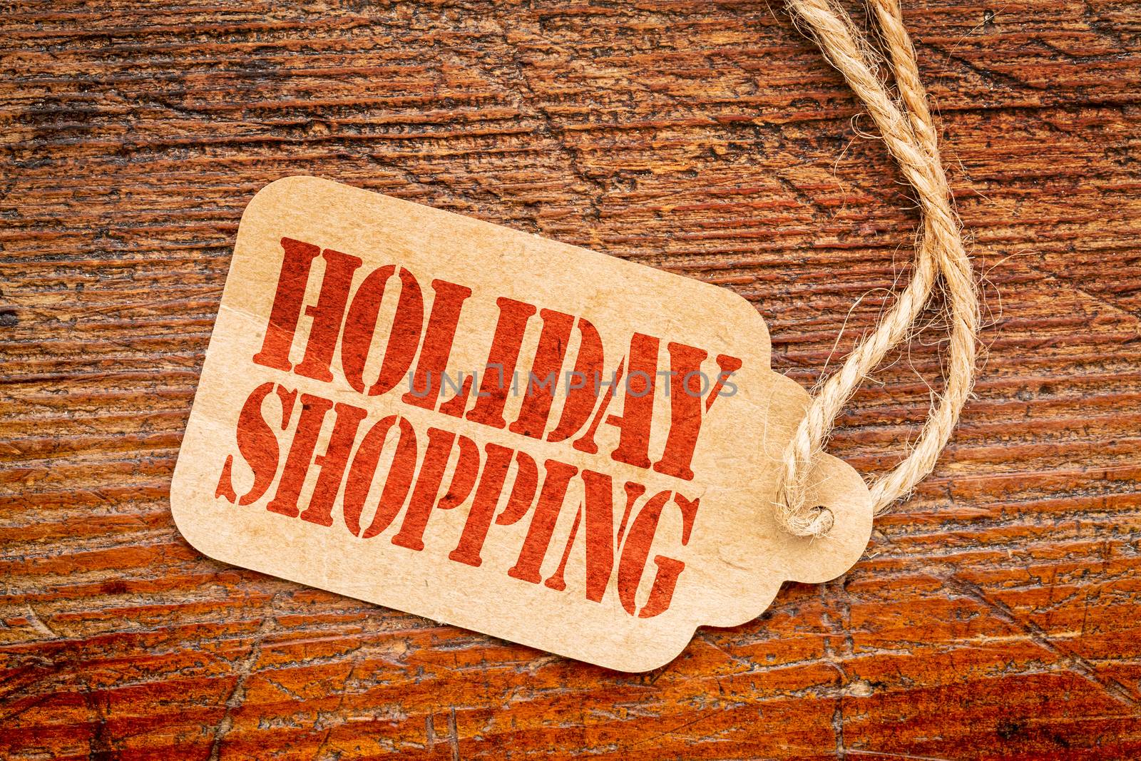 Holiday shopping  sign a paper price tag against rustic red painted barn wood