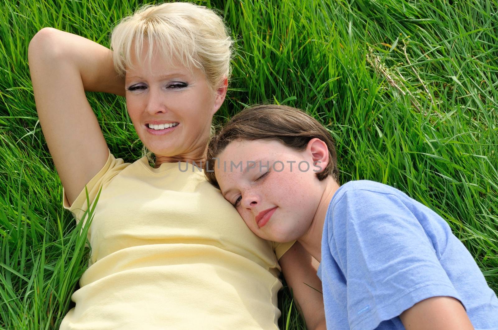 Mother and daughter making a nap on the grass