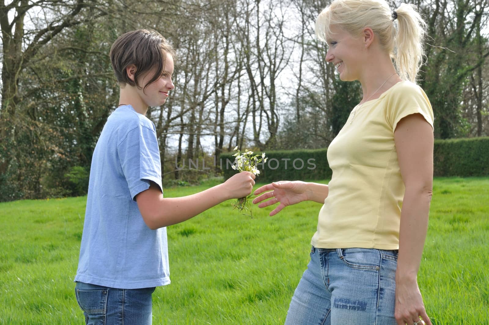 Daughter offering flowers to her mother by BZH22