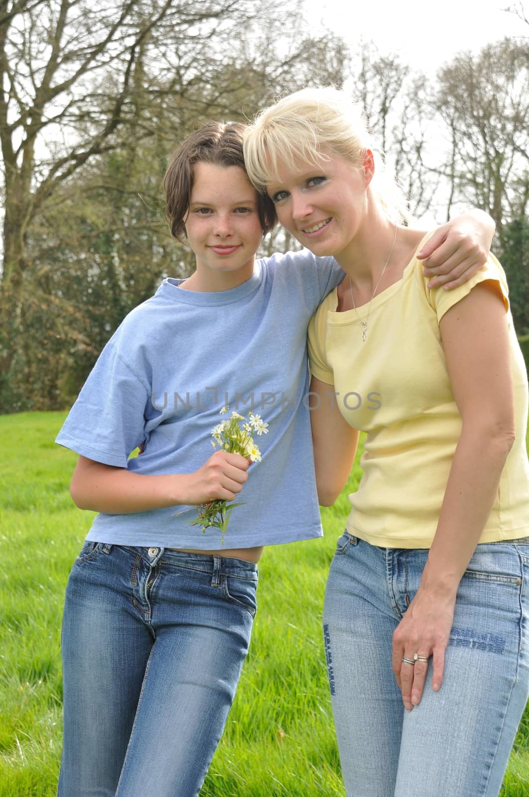 Daughter offering flowers to her mother