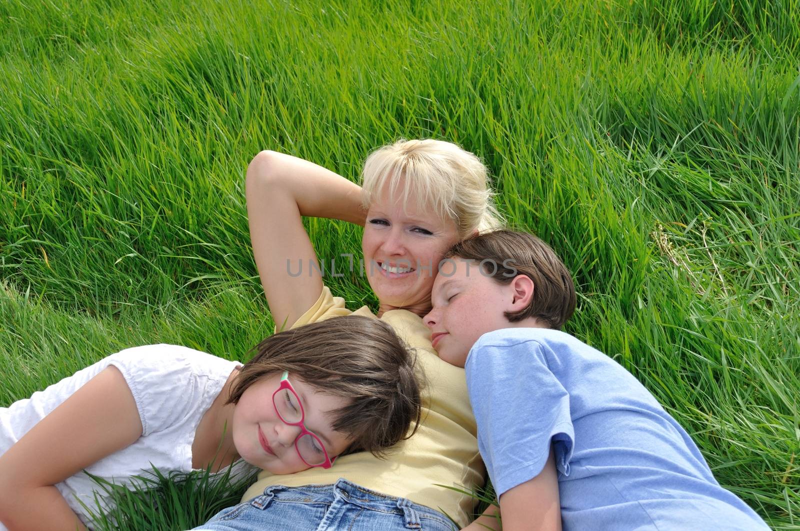 Mother and daughters making a nap on the grass