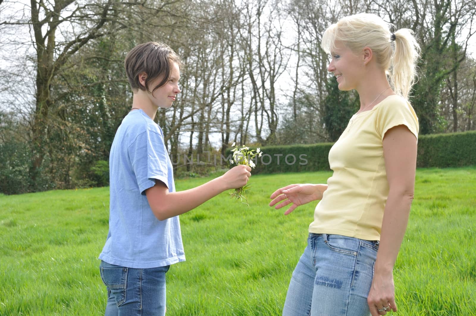 Daughter offering flowers to her mother