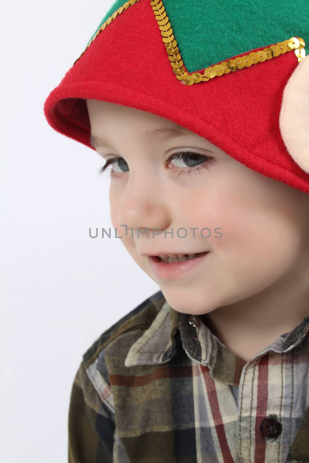 Young boy wearing a christmas elf hat