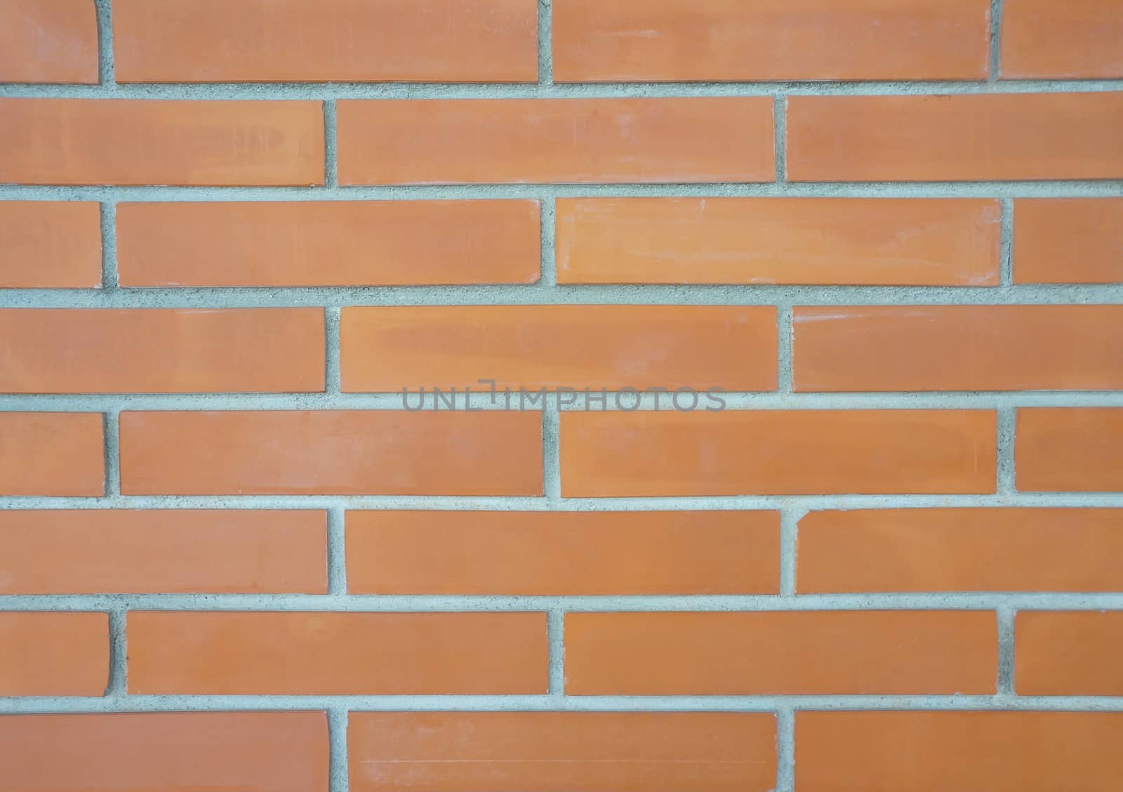 Rectangular shape with a brown brick was put together in a wall.                               