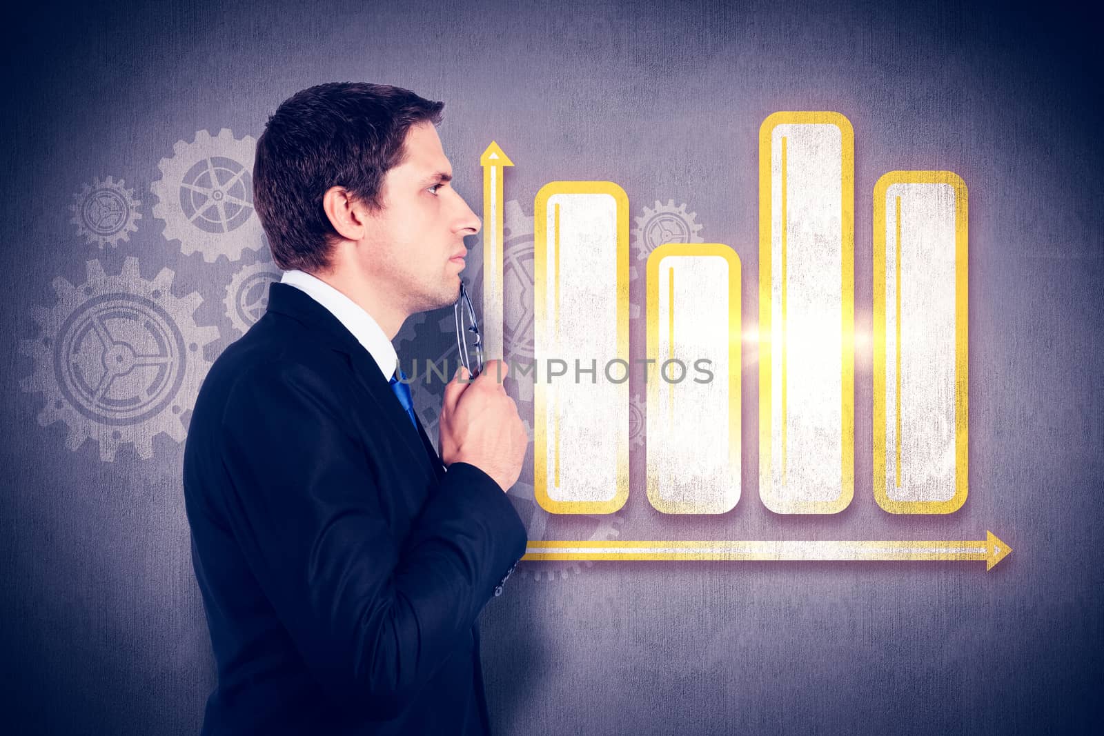 Thinking businessman holding glasses against white and grey background