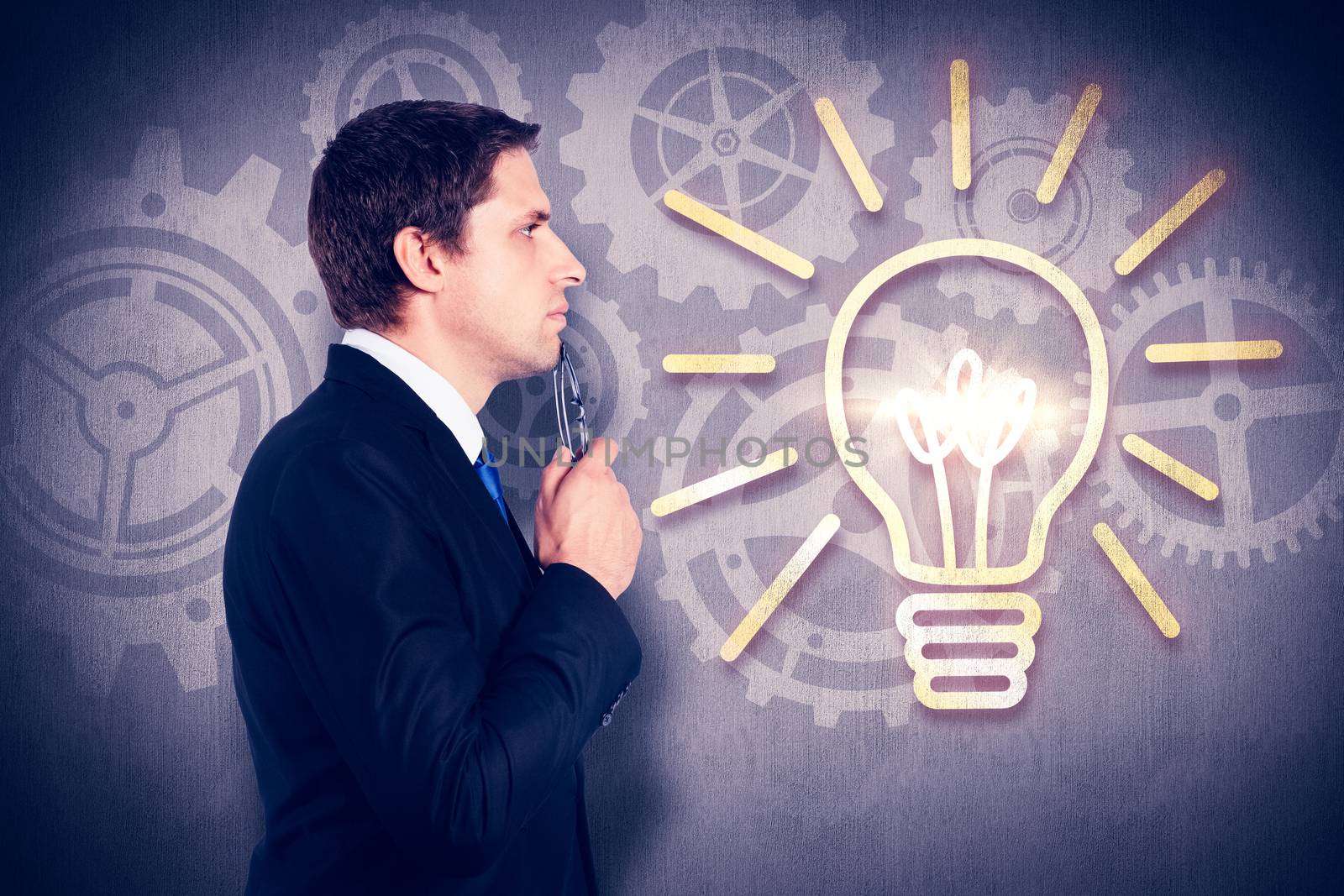 Thinking businessman holding glasses against white and grey background