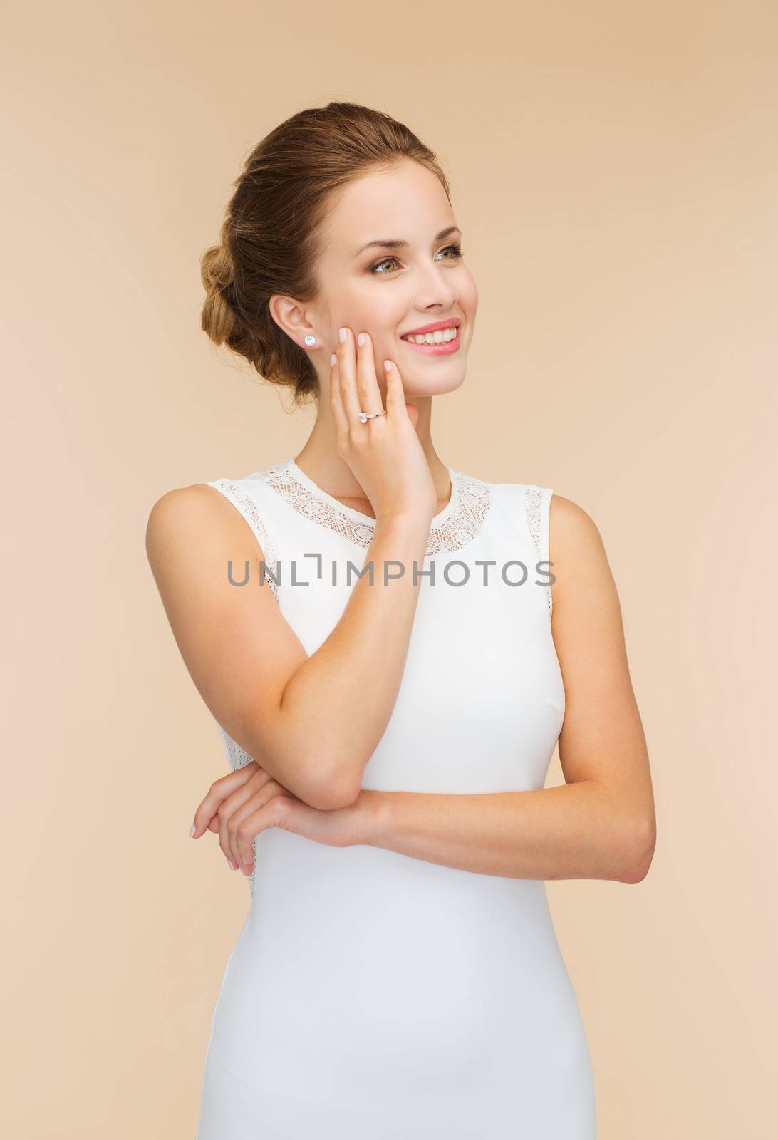 smiling woman in white dress with diamond ring by dolgachov