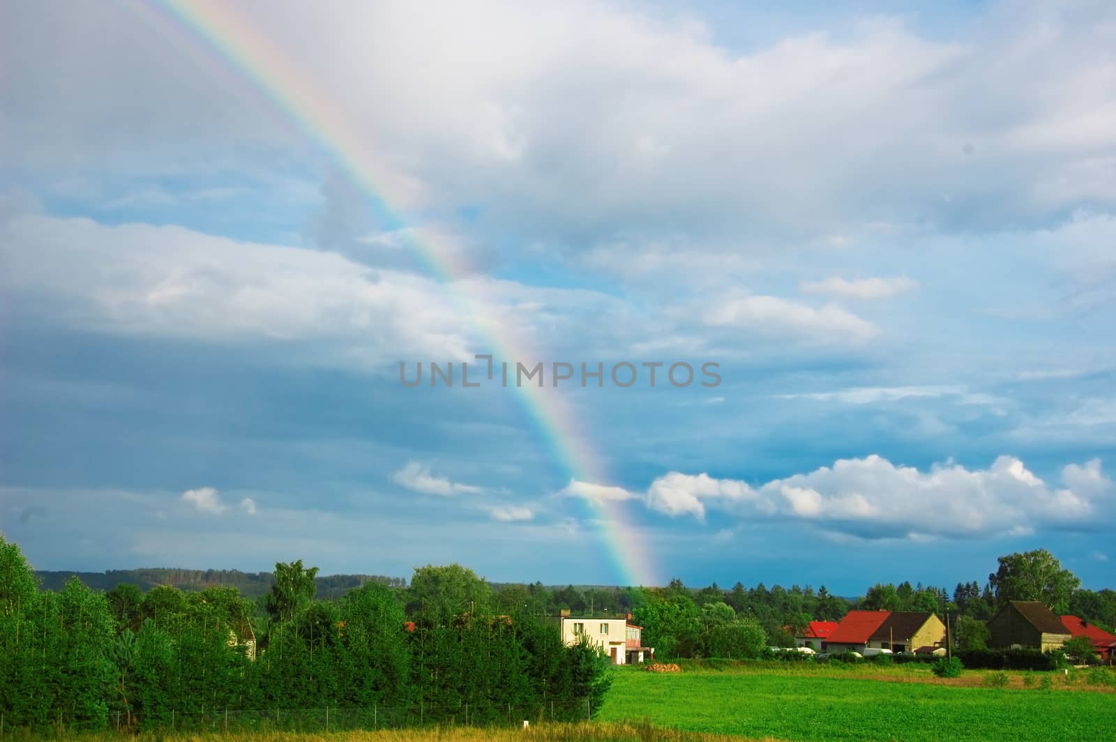 Rainbow over the small village.