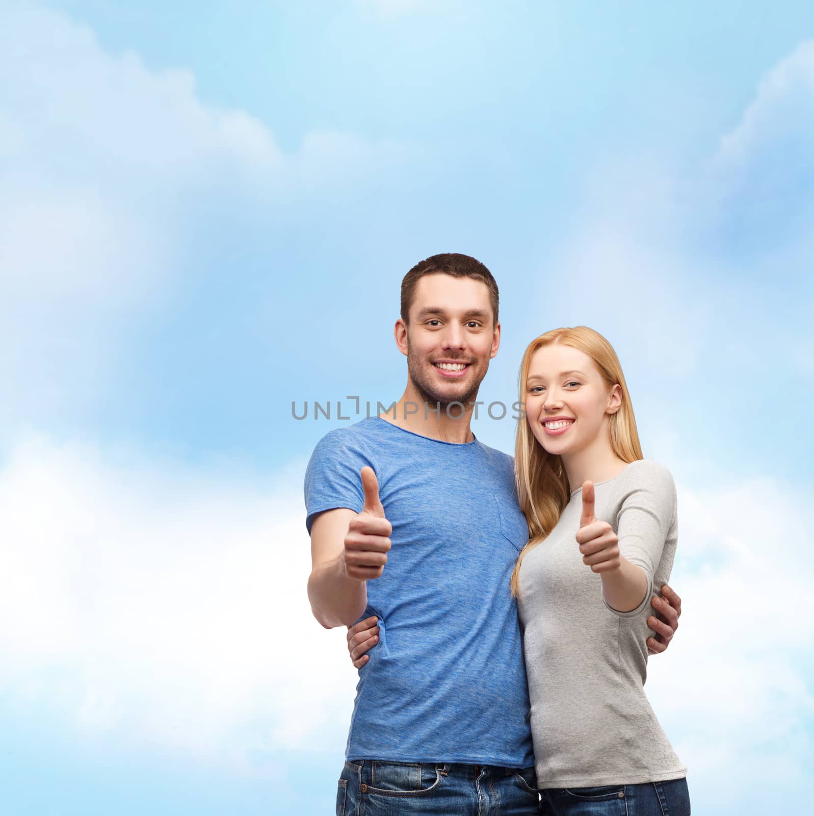 couple, gesture and family concept - smiling couple showing thumbs up