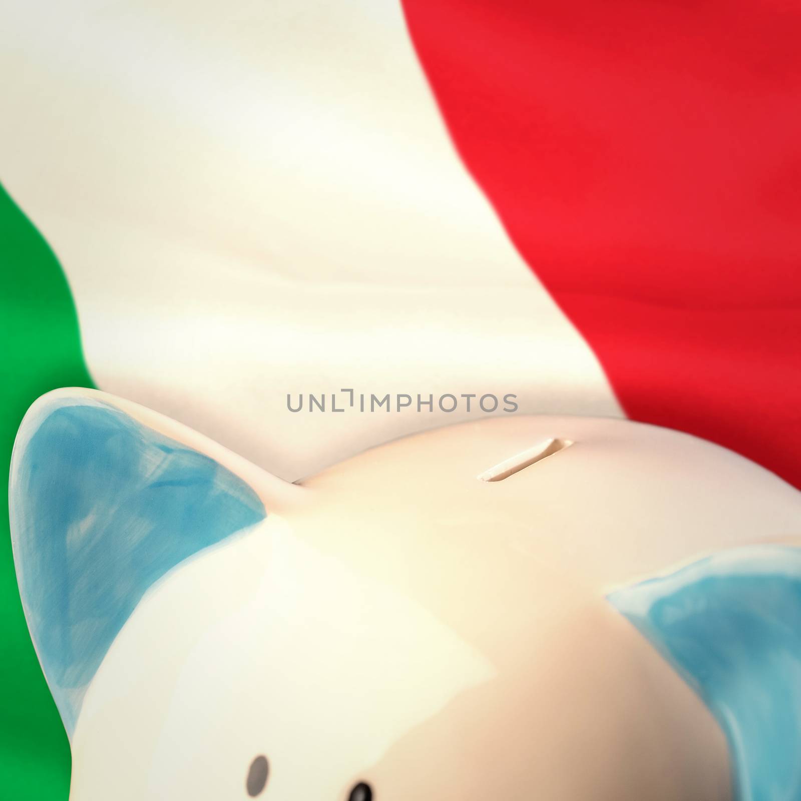 Piggy bank against digitally generated italian national flag