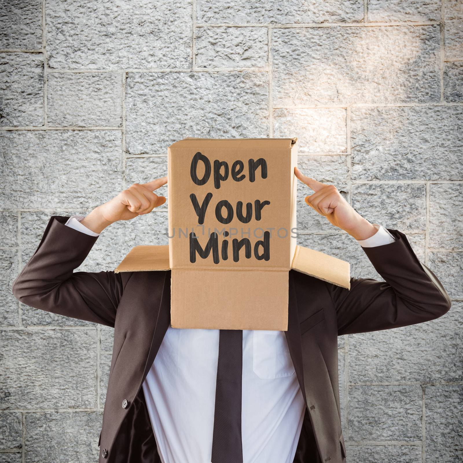 Anonymous businessman pointing to box against grey