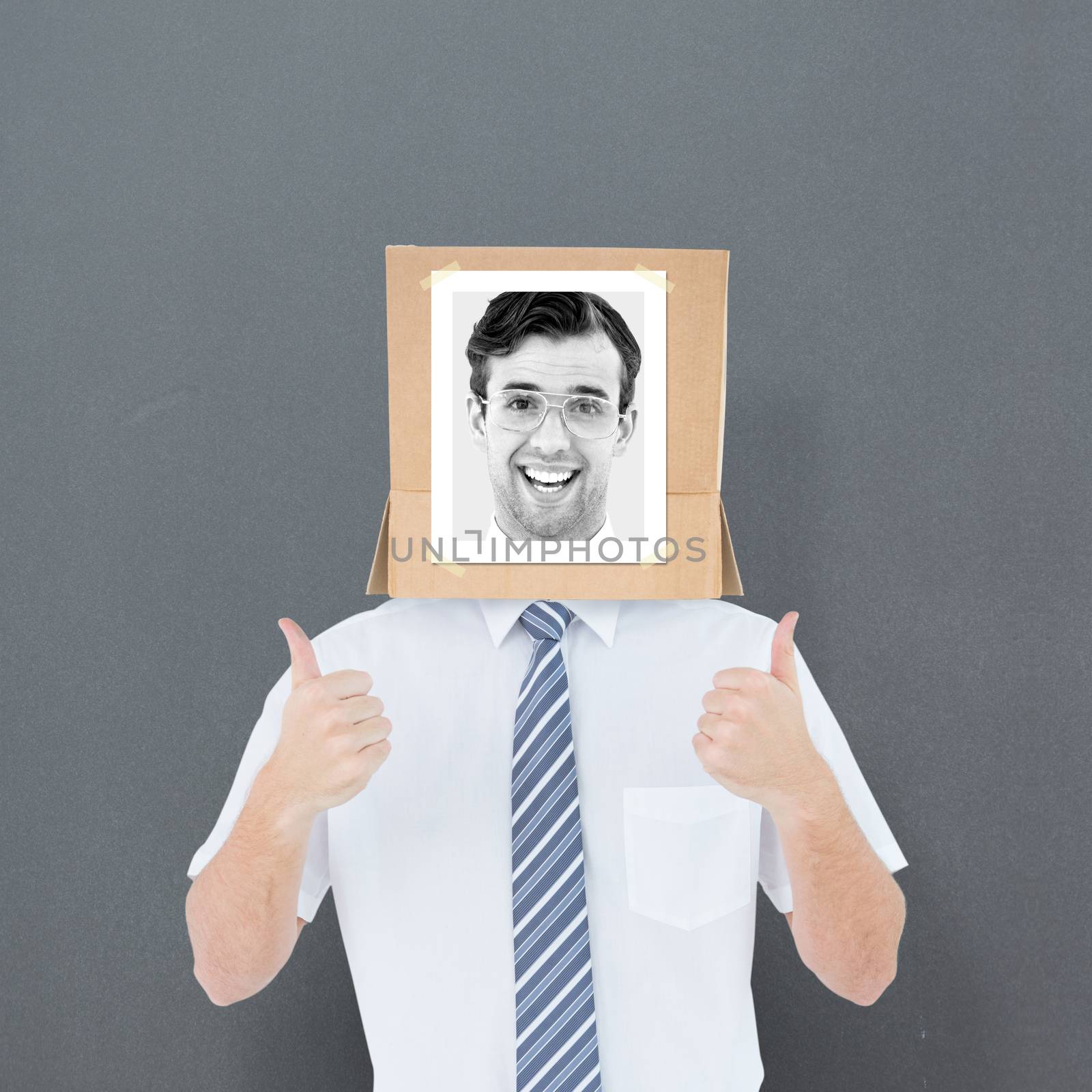 Businessman with photo box on head against grey background