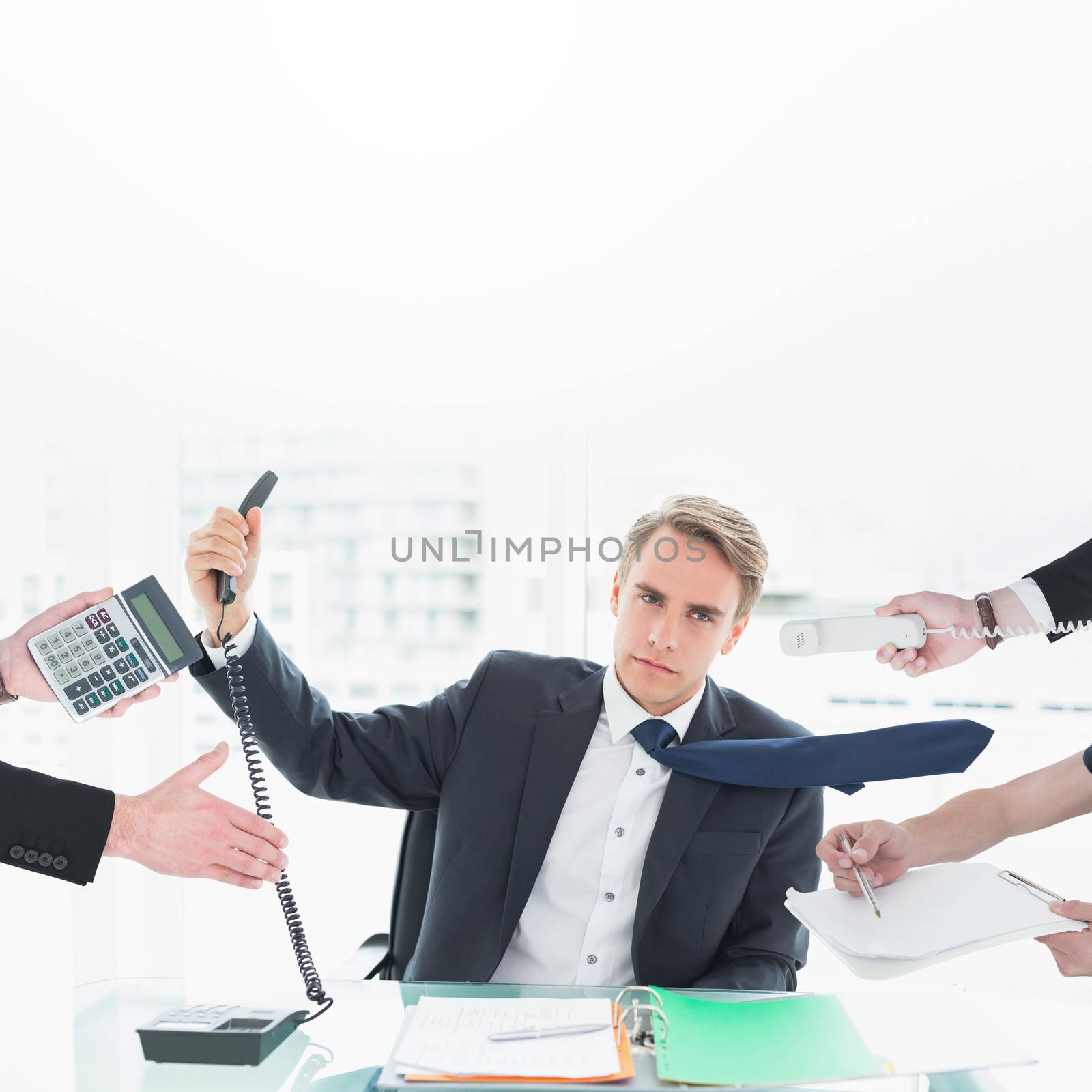Businessman in suit offering his hand against businessman holding out phone at office