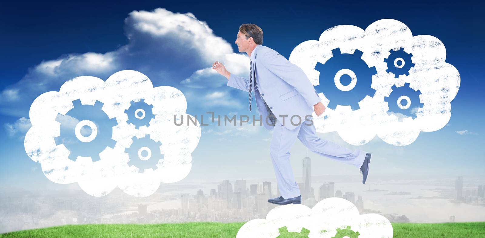 Stepping businessman against blue sky over city