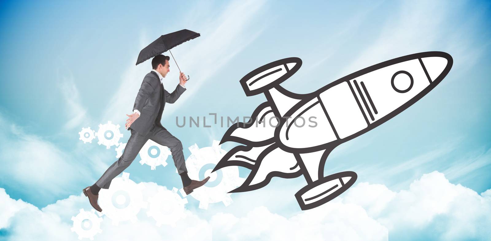 Businessman jumping holding an umbrella against blue sky