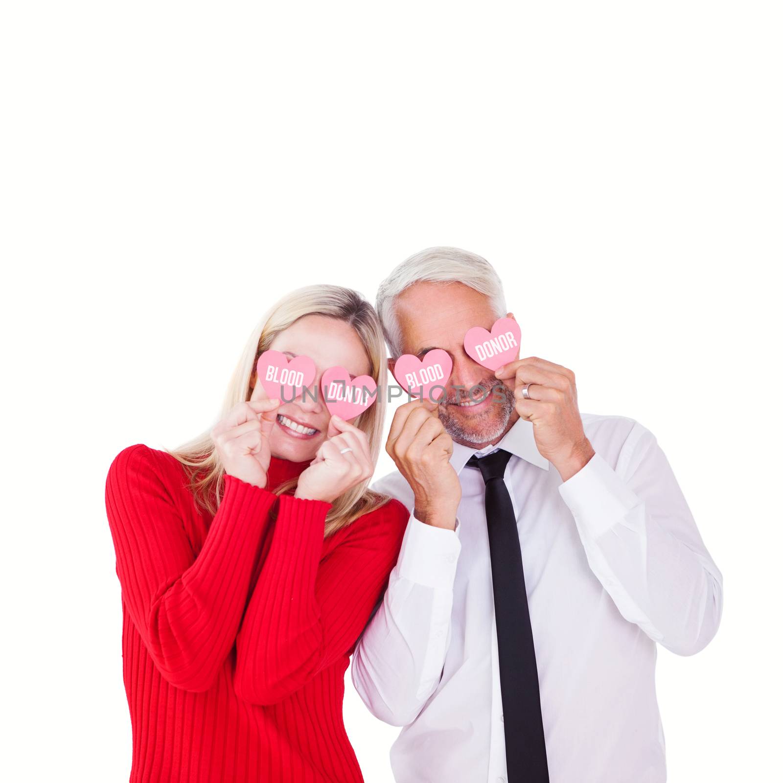 Silly couple holding hearts over their eyes against blood donor