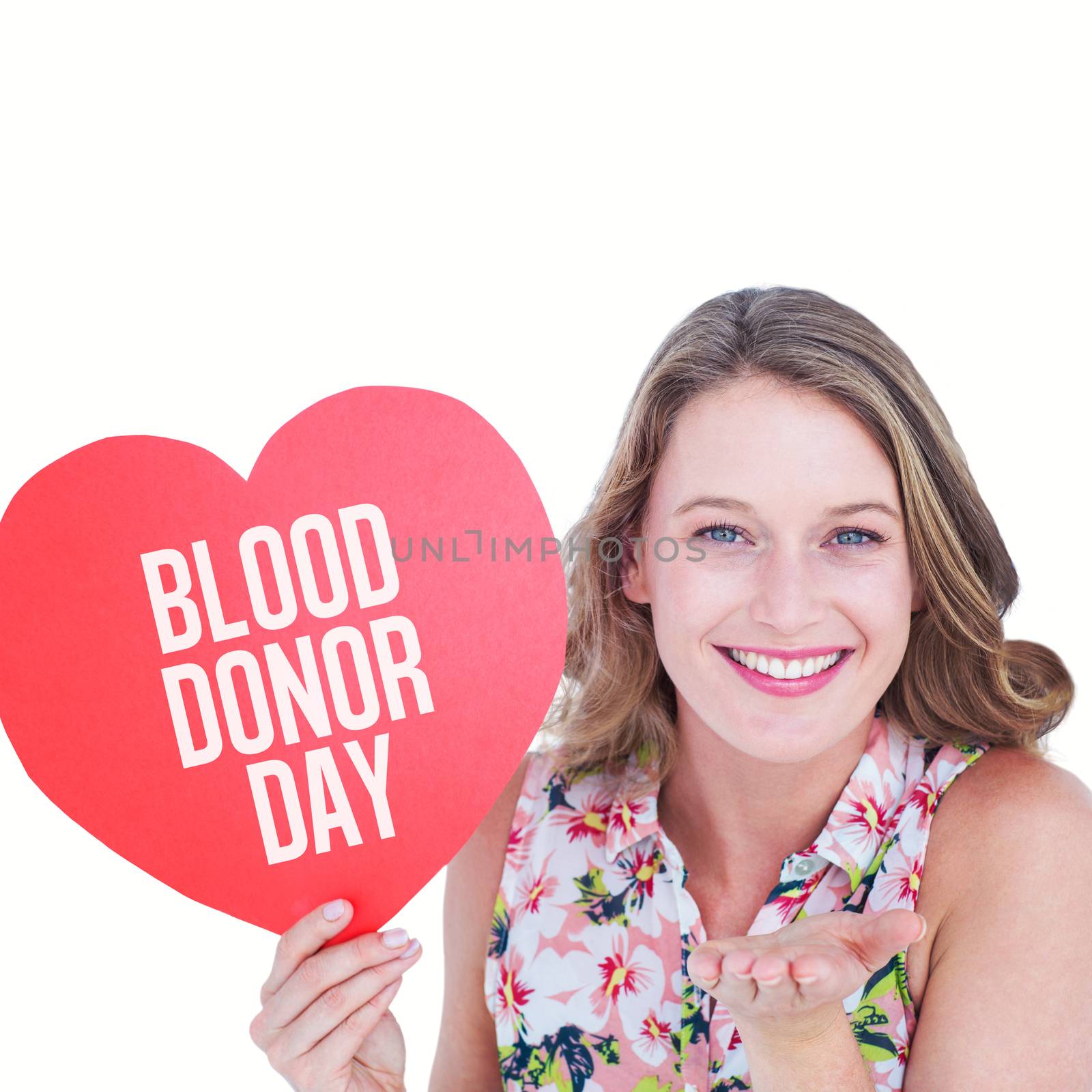 Woman holding heart card and blowing kiss against blood donor day