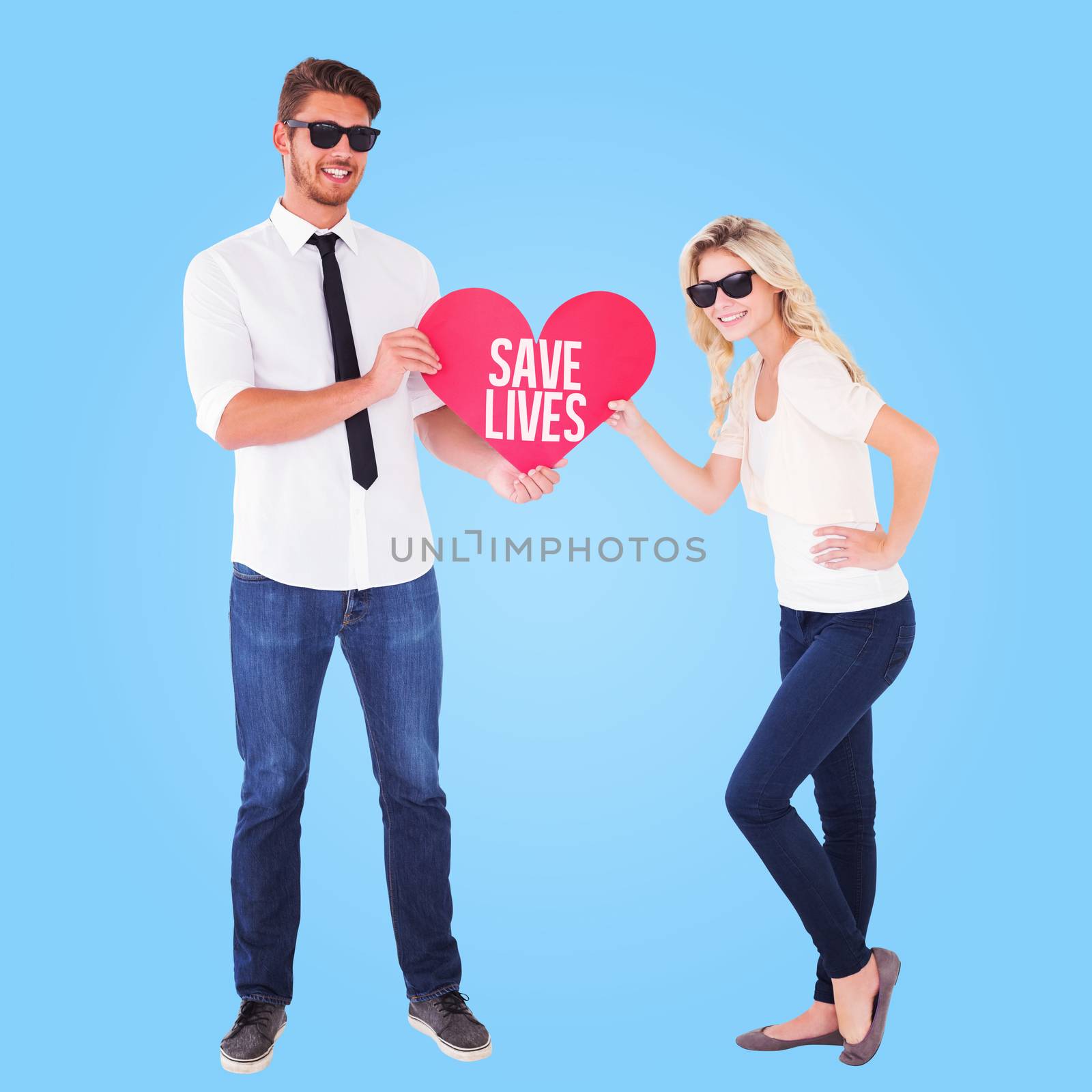 Composite image of cool young couple holding red heart by Wavebreakmedia