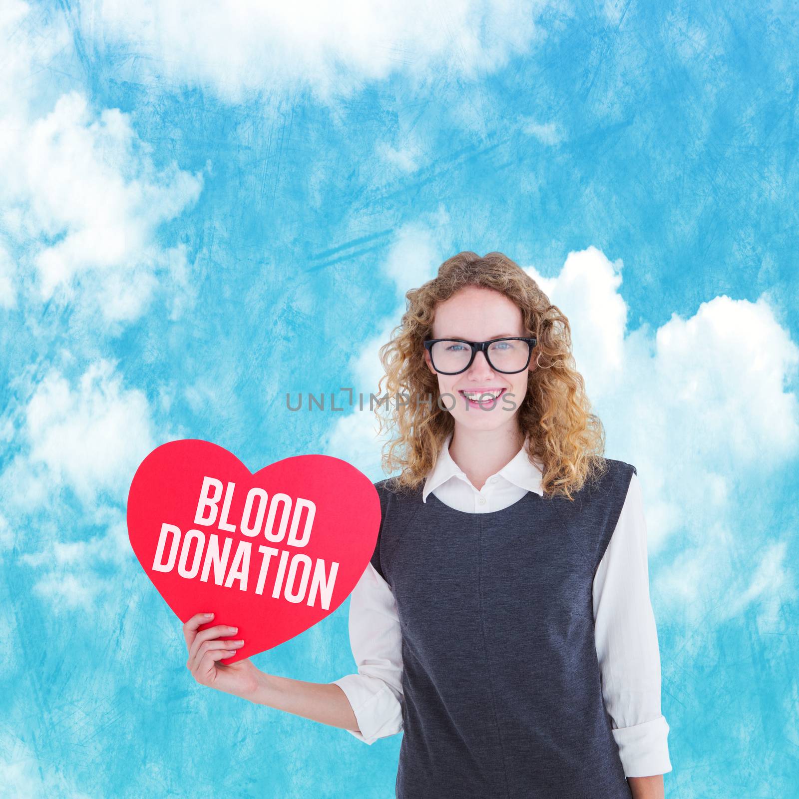 Geeky hipster holding heart card against painted blue sky