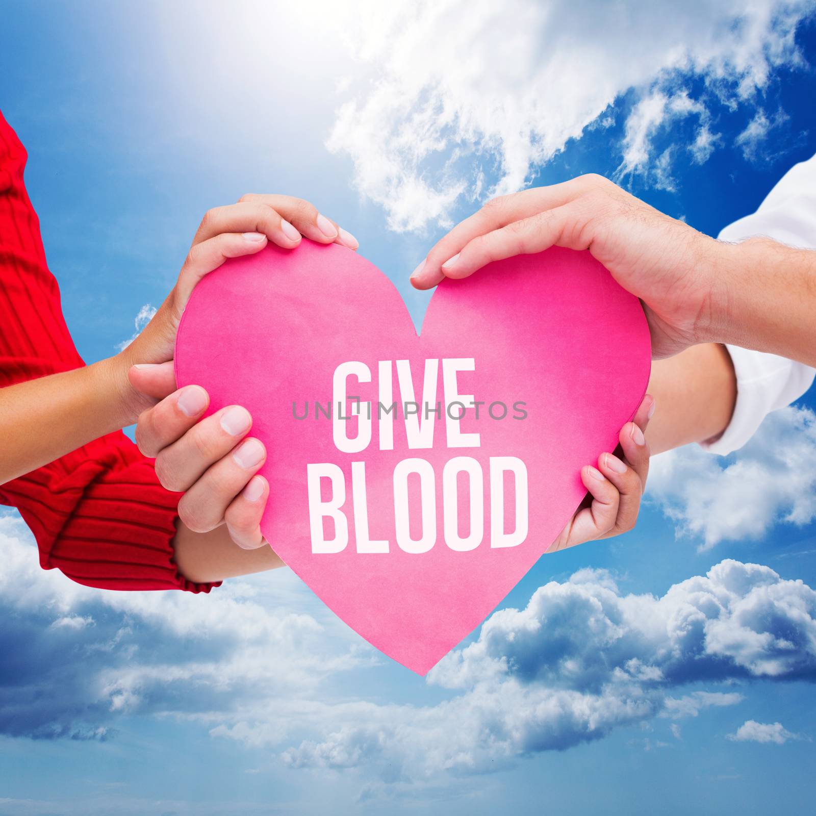 Couple holding a heart against blue sky