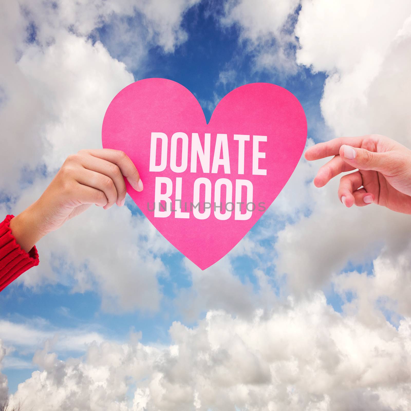 Couple holding a heart against blue sky with white clouds