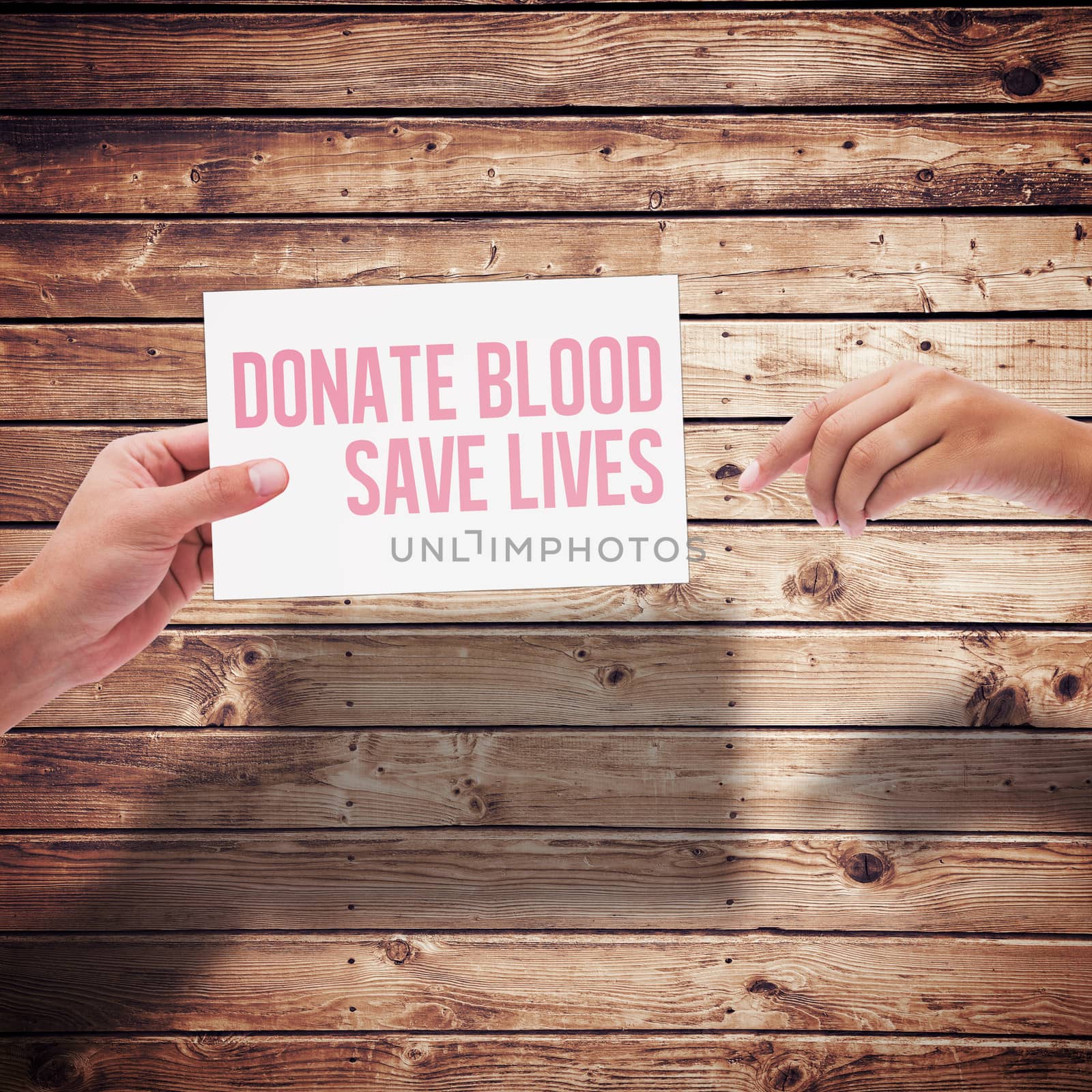 Hands holding card against wooden planks background