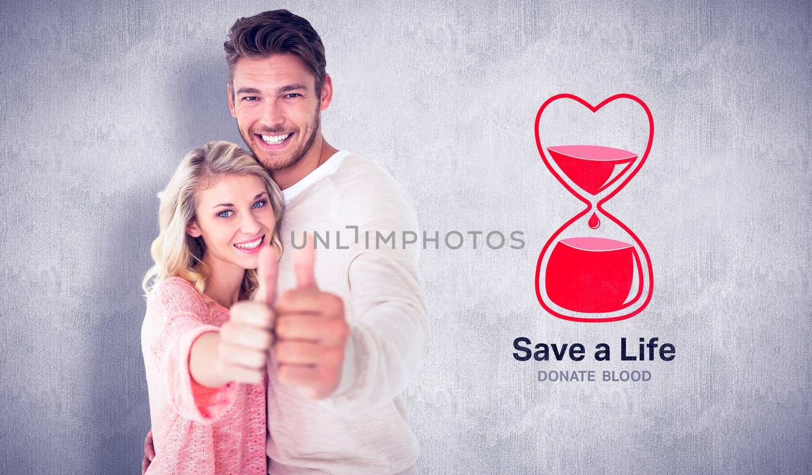 Attractive couple showing thumbs up to camera against white and grey background
