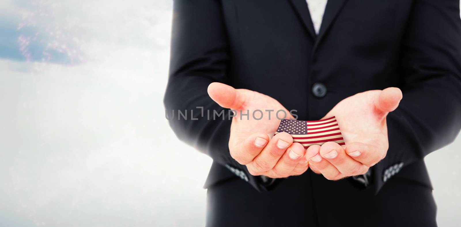 Businessman holding his hands out against colourful fireworks exploding on black background