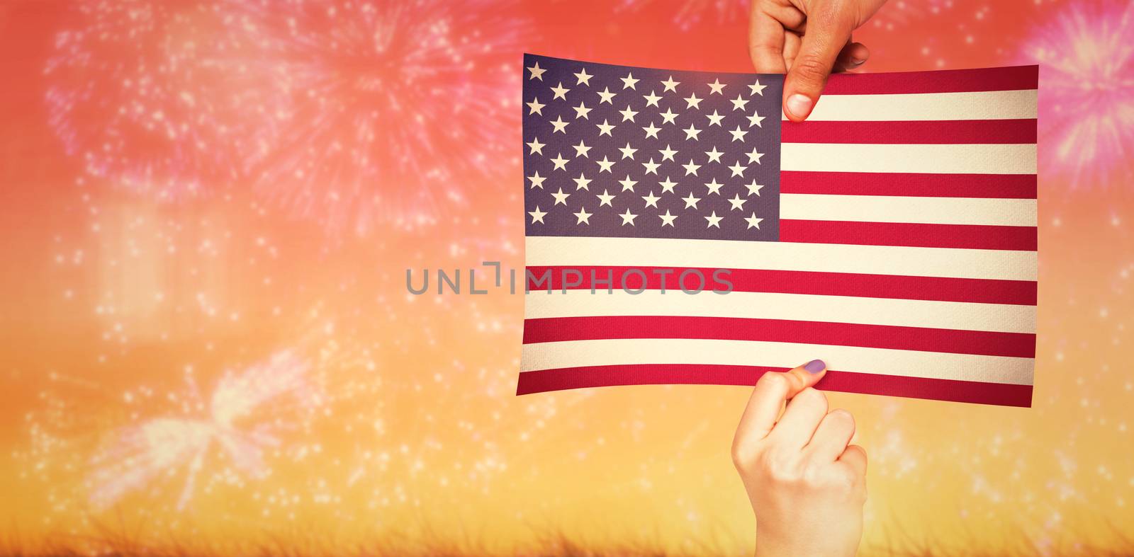 Hands showing against colourful fireworks exploding on black background