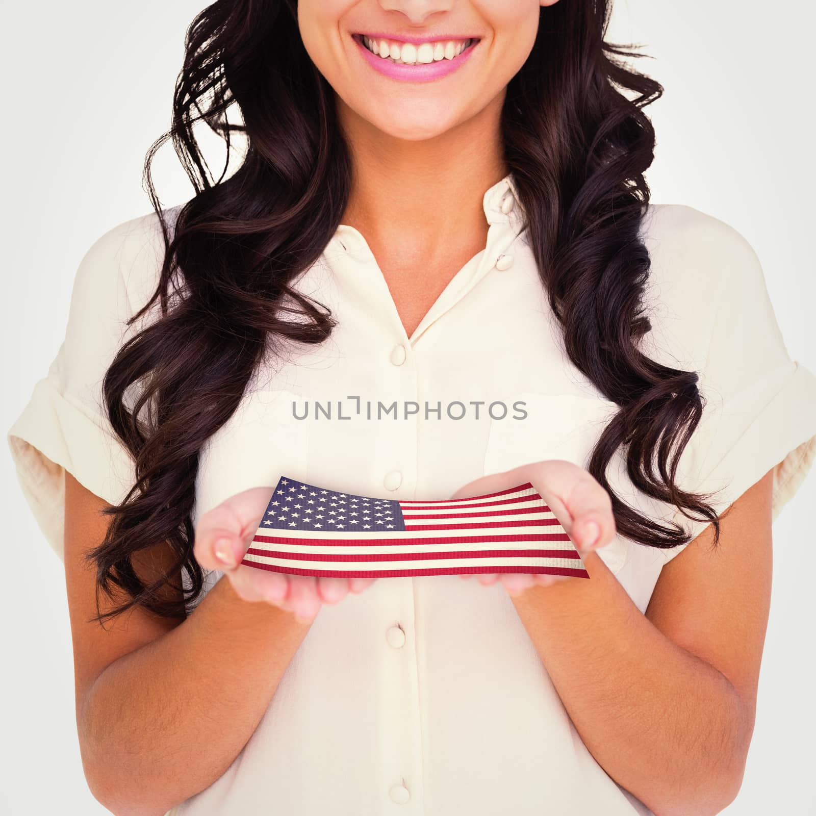 Pretty brunette holding out hands against usa national flag