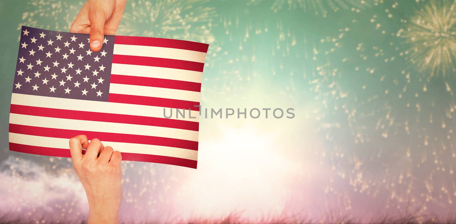 Hands showing against colourful fireworks exploding on black background